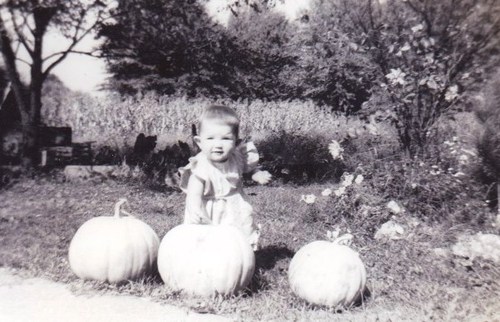 vintage toddler baby with pumpkins