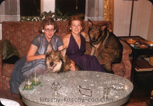 vintage color photo of two women with wolf-like dogs